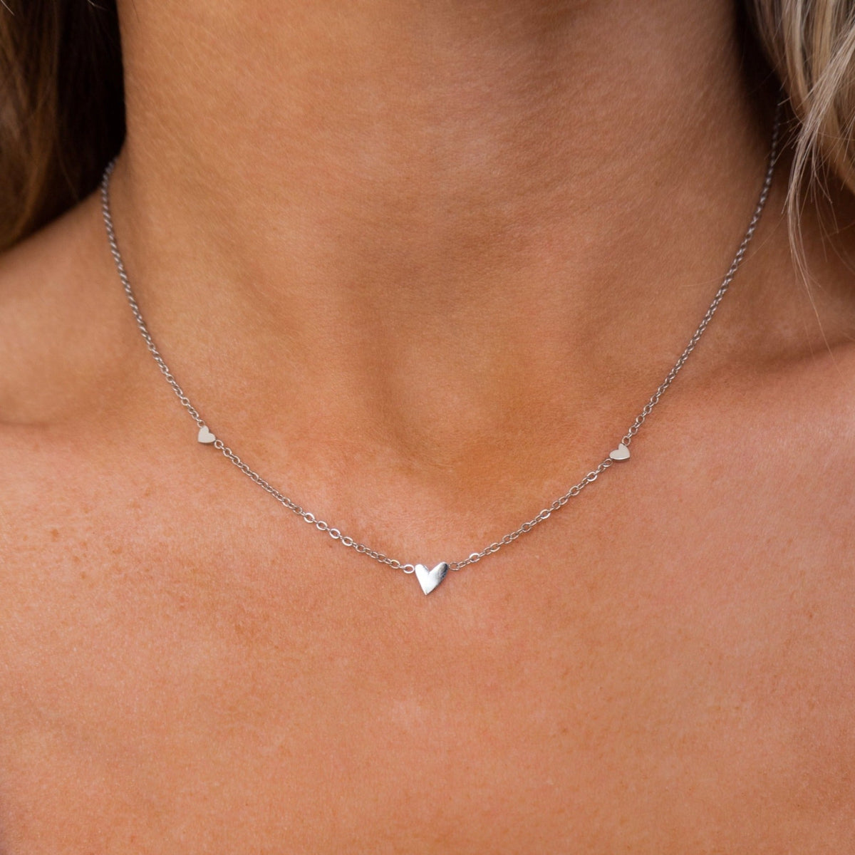 Silver necklace with three hearts