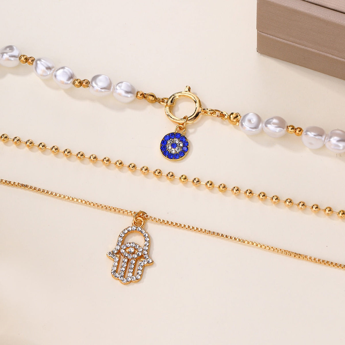 Jade – Multi-level Pearl Necklace and Hamsa