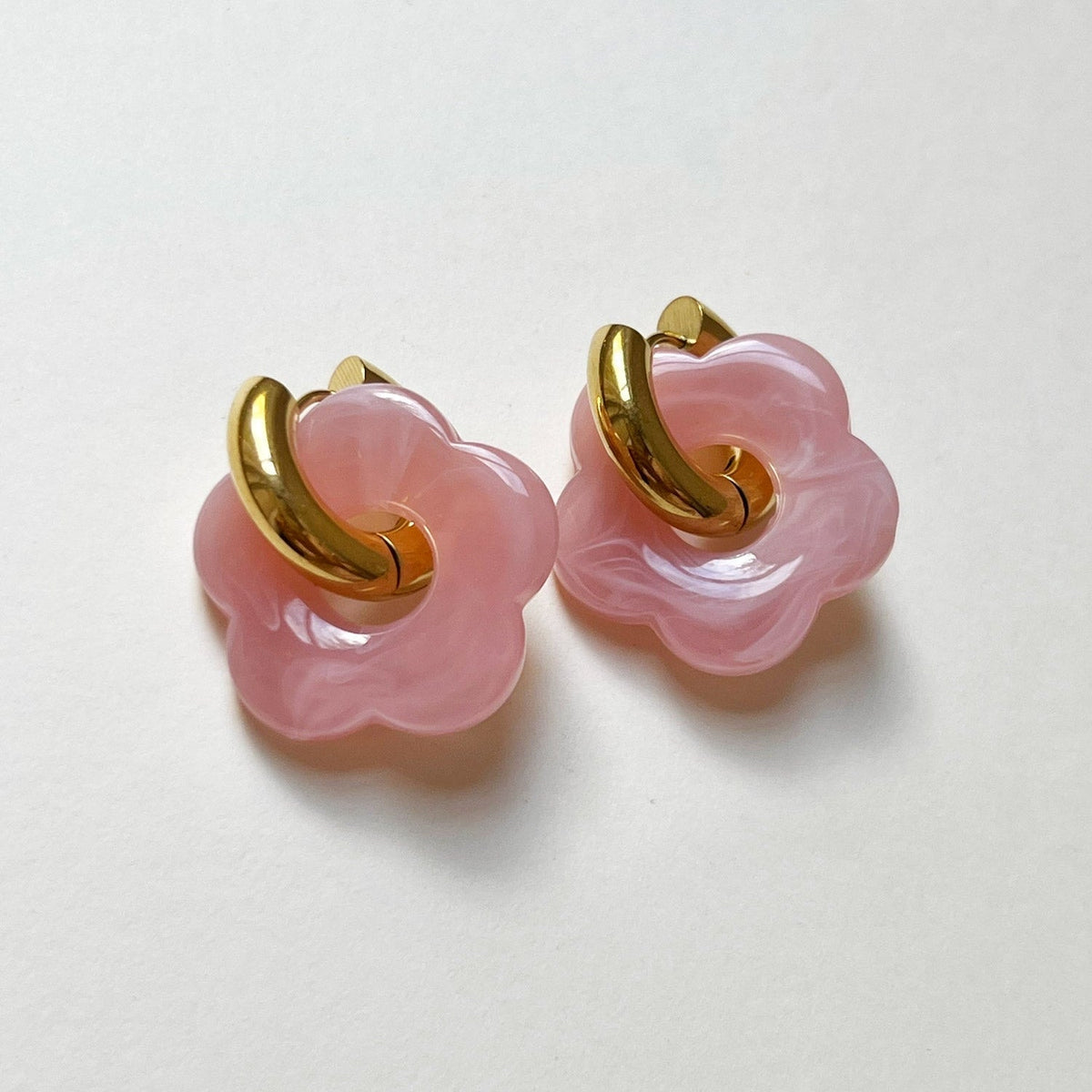 Pink donut hoop earrings with flower charm