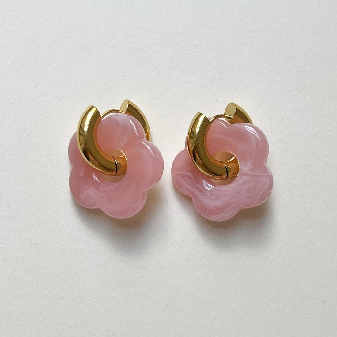 Pink donut hoop earrings with flower charm