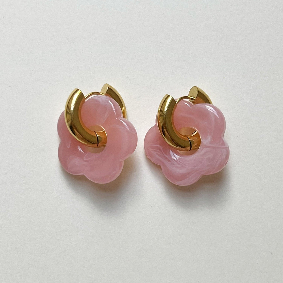 Pink donut hoop earrings with flower charm